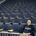 Audio tech Tim Ofarrelo sits in an empty seating section before the game between Michigan and Binghamton on Tuesday. Daniel Brenner I AnnArbor.com